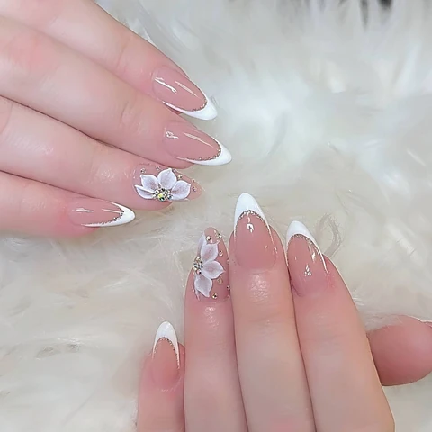 White French tips with flower and gem accents, from the Solar Nails gallery.