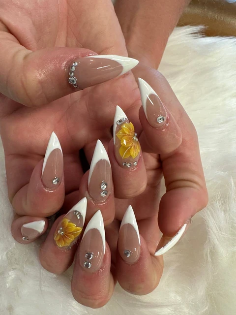 White French tips with yellow flowers and gem accents, from the Solar Nails gallery.